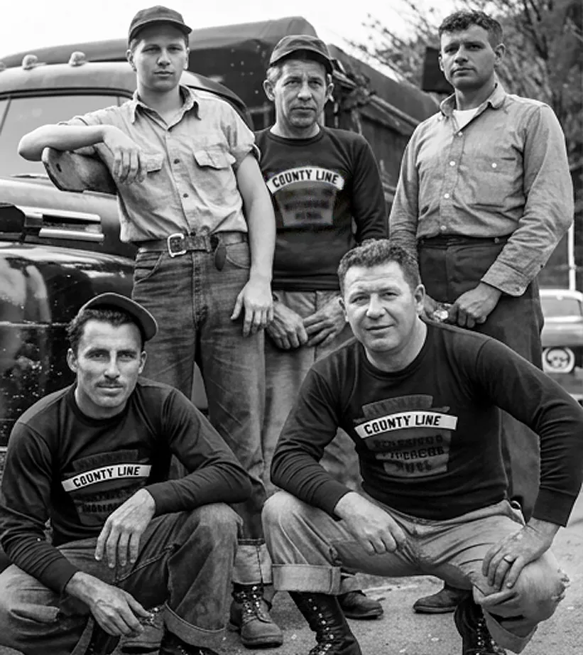 Image of old truck and employees
